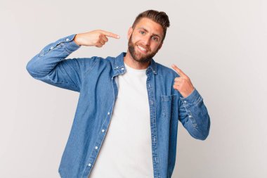 Genç ve yakışıklı bir adam, kendine güvenerek gülümsüyor.