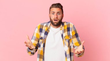 Genç ve yakışıklı bir adam son derece şaşkın ve şaşırmış hissediyor.