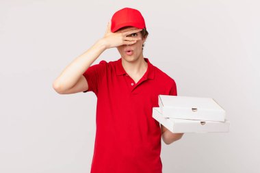 pizza deliver man looking shocked, scared or terrified, covering face with hand