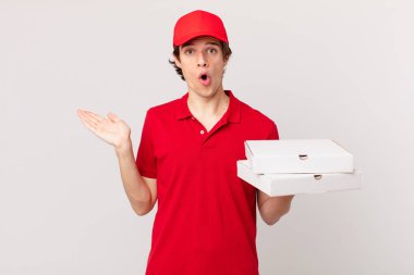 pizza deliver man looking surprised and shocked, with jaw dropped holding an object