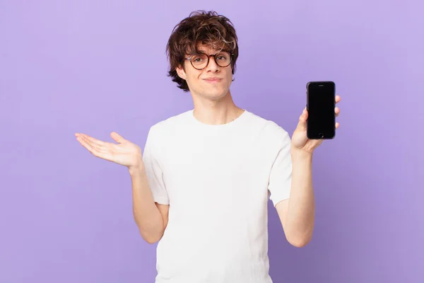 Young Man Feeling Puzzled Confused Doubting Holding Cell — Stockfoto