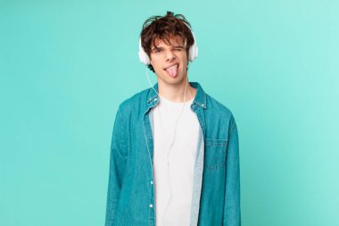 young man with headphones feeling disgusted and irritated and tongue out clipart