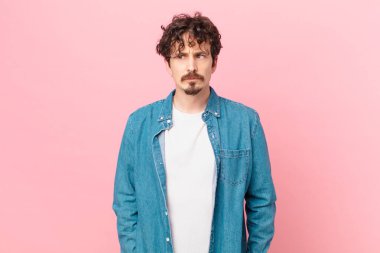 Genç ve yakışıklı bir adam üzgün, üzgün ya da kızgın hissediyor.