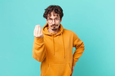 Genç yakışıklı adam kapiş ya da para hareketi yapıyor, sana ödemeni söylüyor.