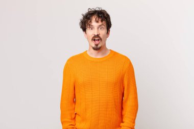 Genç yakışıklı adam çok şaşırmış ya da şaşırmış görünüyor.