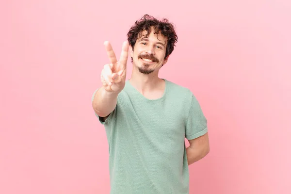 Joven Hombre Guapo Sonriendo Mirando Feliz Haciendo Gestos Victoria Paz — Foto de Stock