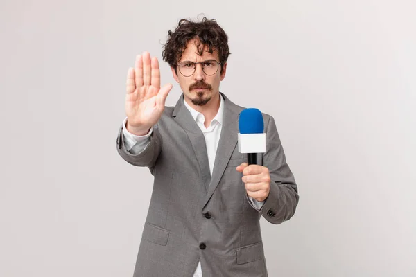 Young Man Journalist Looking Serious Showing Open Palm Making Stop — Foto de Stock