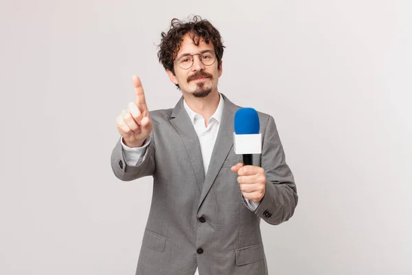 Young Man Journalist Smiling Looking Friendly Showing Number One —  Fotos de Stock