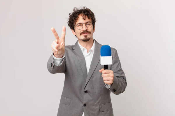 Young Man Journalist Smiling Looking Friendly Showing Number Two —  Fotos de Stock