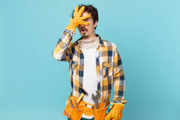 Young Handyman Housekeeper Looking Shocked Scared Terrified Covering Face Hand — Stock Photo, Image