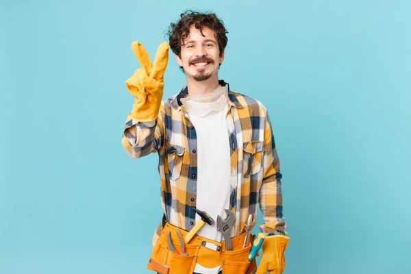 Young Handyman Housekeeper Smiling Looking Friendly Showing Number Two — Foto de Stock