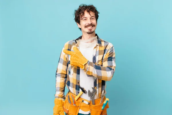 Young Handyman Housekeeper Smiling Cheerfully Feeling Happy Pointing Side — Foto de Stock