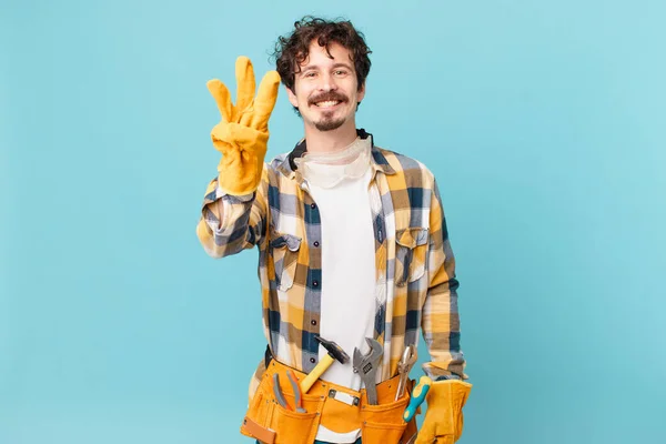 Young Handyman Housekeeper Smiling Looking Friendly Showing Number Three — Foto de Stock