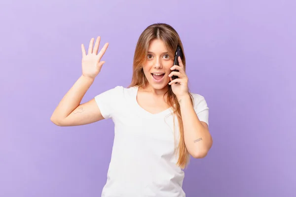 Young Woman Cell Phone Smiling Happily Waving Hand Welcoming Greeting — Stock Photo, Image