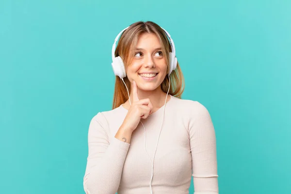 Jovem Com Fones Ouvido Sorrindo Feliz Sonhando Acordado Duvidando — Fotografia de Stock