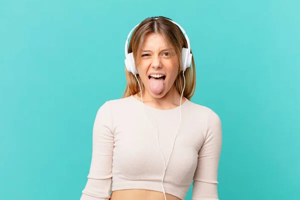 Young Woman Headphones Cheerful Rebellious Attitude Joking Sticking Tongue Out — Stock Photo, Image