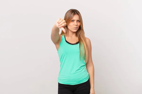 Young Pretty Fitness Woman Feeling Cross Showing Thumbs — Stock Photo, Image