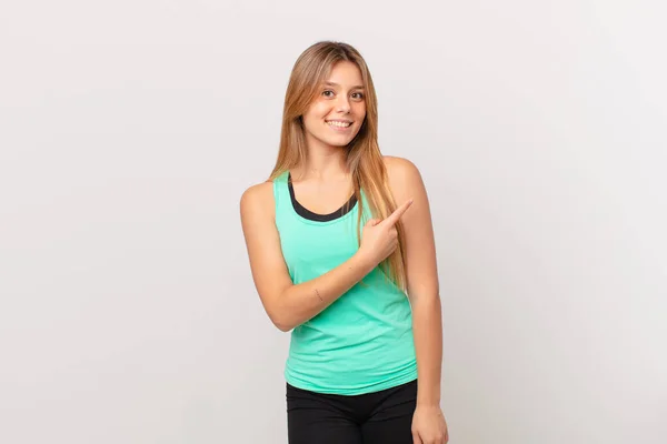 Joven Bonita Mujer Fitness Sonriendo Alegremente Sintiéndose Feliz Señalando Lado — Foto de Stock