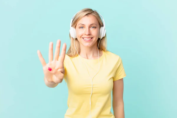 Young Blonde Woman Smiling Looking Friendly Showing Number Four Listening — Stockfoto