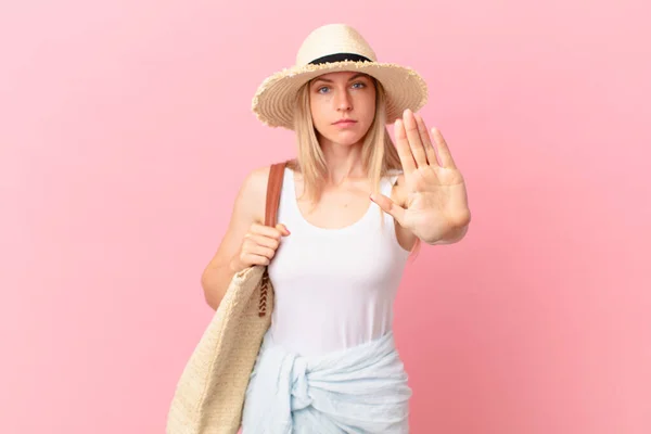 Young Blonde Woman Looking Serious Showing Open Palm Making Stop — Stock Photo, Image