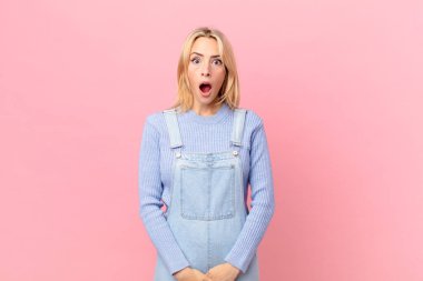 Genç sarışın kadın çok şaşırmış ya da şaşkın görünüyor.