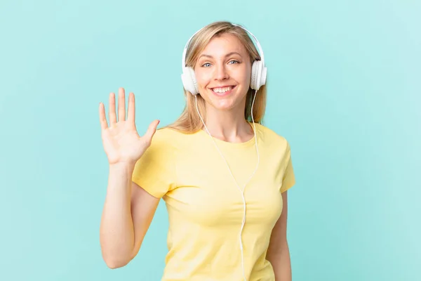 Young Blonde Woman Smiling Happily Waving Hand Welcoming Greeting You — Fotografia de Stock