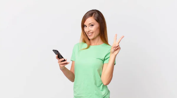 Pretty Woman Smiling Looking Happy Gesturing Victory Peace Using Smartphone — Stock Photo, Image