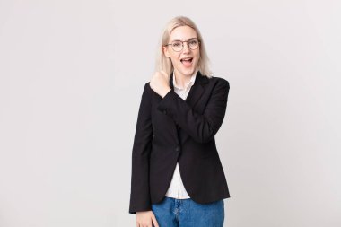 Sarışın, güzel bir kadın kendini mutlu hissediyor ve bir meydan okumayla yüzleşiyor ya da kutluyor. iş kavramı