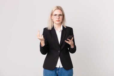 sarışın güzel bir kadın kızgın, sinirli, asi ve agresif ve elinde bir cep telefonu tutuyor.