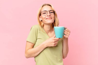 Sarışın, güzel kadın kahve içiyor.