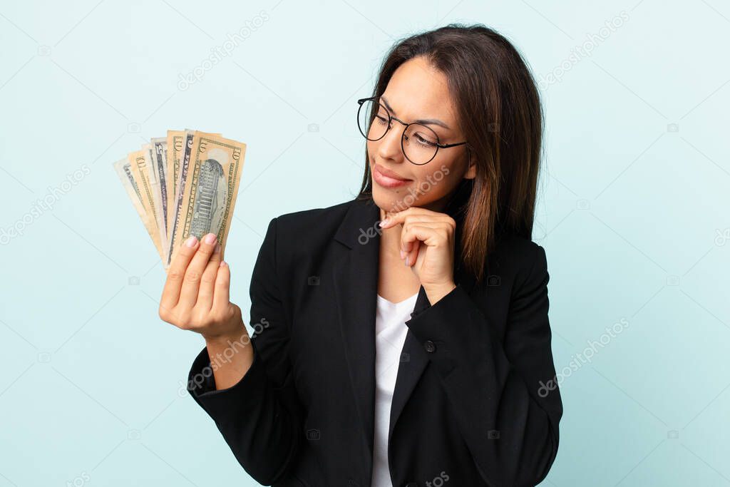 young hispanic businesswoman with dollar banknotes