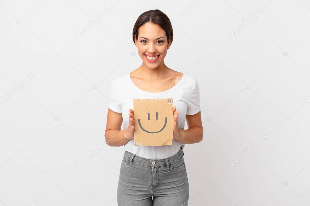 young hispanic woman holding a smiley face banner