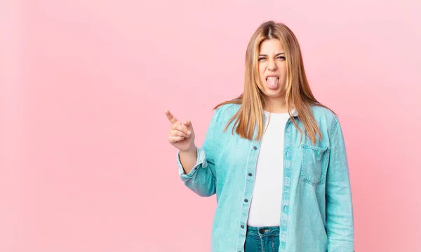 Curvy pretty blonde woman feeling disgusted and irritated and tongue out — Stock Image Curvy Pretty Blonde Woman Feeling Disgusted Irritated Tongue Out Stock Picture