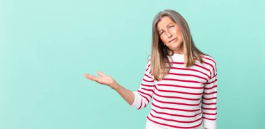 Güzel orta yaşlı kadın kafası karışmış ve şaşkın görünüyor.