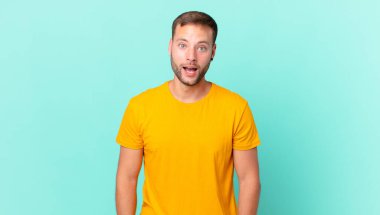 handsome blonde man looking very shocked or surprised