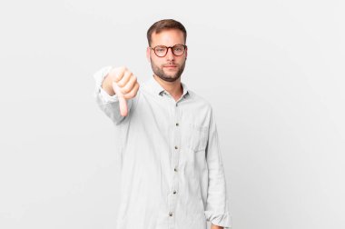 handsome blonde man feeling cross,showing thumbs down