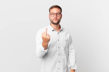 handsome blonde man feeling angry, annoyed, rebellious and aggressive