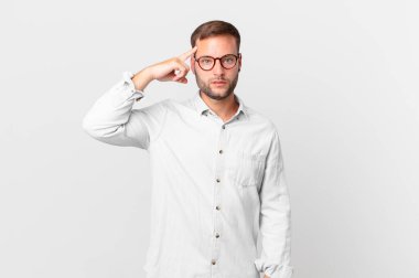 handsome blonde man feeling confused and puzzled, showing you are insane