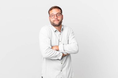 handsome blonde man shrugging, feeling confused and uncertain