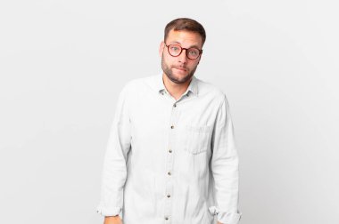 handsome blonde man looking puzzled and confused
