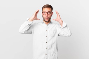 handsome blonde man screaming with hands up in the air