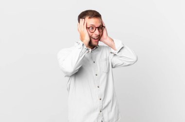 handsome blonde man feeling happy, excited and surprised
