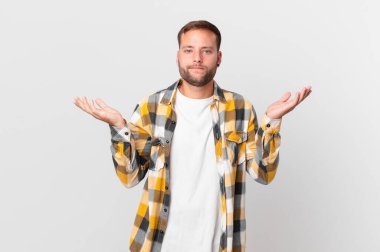 handsome blonde man feeling puzzled and confused and doubting