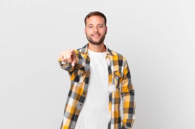 handsome blonde man pointing at camera choosing you