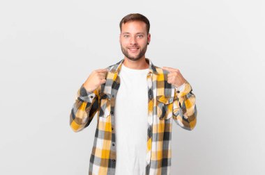 handsome blonde man feeling happy and pointing to self with an excited