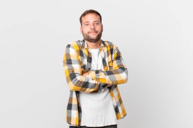 handsome blonde man shrugging, feeling confused and uncertain