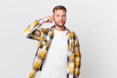 handsome blonde man feeling confused and puzzled, showing you are insane