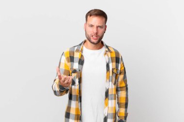 handsome blonde man looking angry, annoyed and frustrated