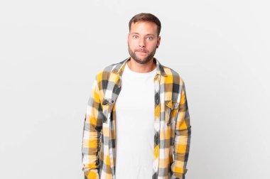 handsome blonde man looking puzzled and confused