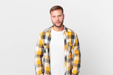 handsome blonde man feeling puzzled and confused